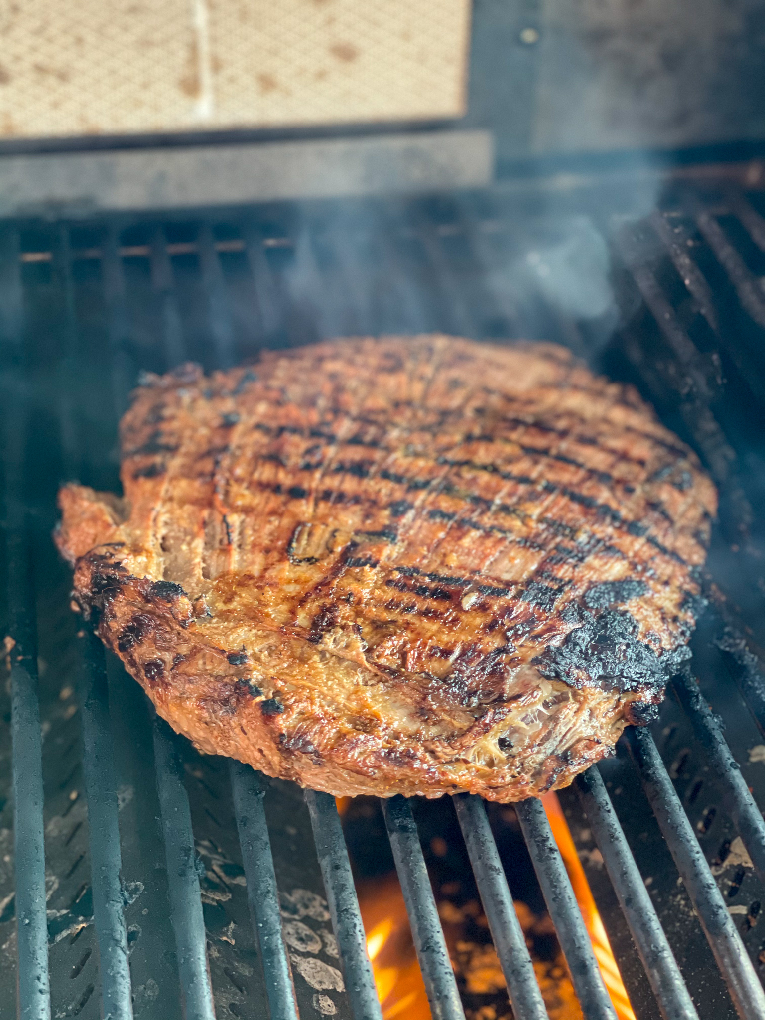 Flank steak on outlet charcoal grill